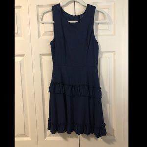 Navy dress with skirt ruffle detail.